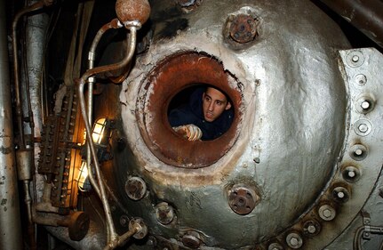 Lt. j.g. Christopher Tantillo, marine inspector at U. S. Coast Guard Activites New York, inspects the inside of a steam drum on board a steam-propelled passenger vessel