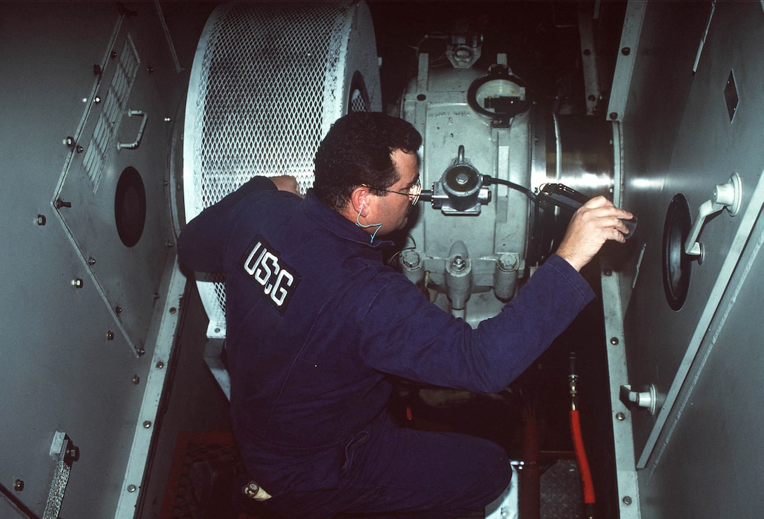 Coast Guard Chief Warrant Officer Ray Cain, marine safety inspector for Marine Safety Office Puget Sound inspects the engine room of the ferryboat Spokane