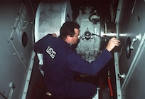 Coast Guard Chief Warrant Officer Ray Cain, marine safety inspector for Marine Safety Office Puget Sound inspects the engine room of the ferryboat Spokane