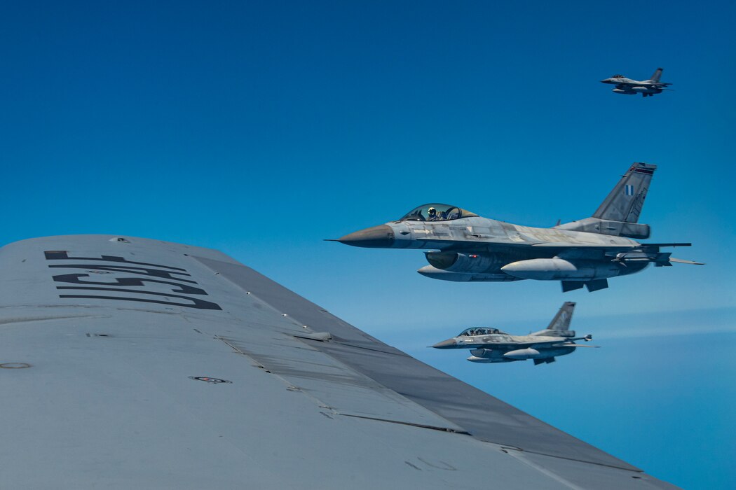 A KC-135 Stratotanker and F-16 Fighting Falcons fly over Greece