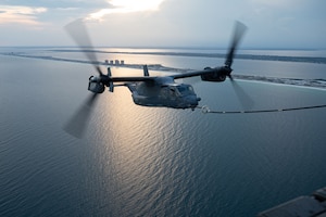 A CV-22 Osprey refuels from an MC-130J Commando II