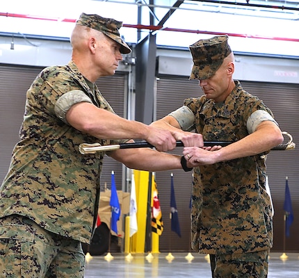 Sgt. Maj. Brian R. Drechsler, right, incoming sergeant major, Marine Corps Logistics Command (MARCORLOGCOM), accepts a ceremonial noncommissioned officer sword from Maj. Gen. Keith D. Reventlow, commanding general, MARCORLOGCOM during a relief and appointment ceremony at Marine Corps Logistics Base Albany, Ga., June 30. The passing of the sword represents the transferring of accountability and authority of all MARCORLGCOM enlisted Marines to Drechsler. Drechsler, a native of Everett, Wash., served as sergeant major, Headquarters and Support Battalion, Marine Corps Installations Pacific, Okinawa, Japan. Sgt. Maj. Jason B. Hammock, MARCORLOGCOM’s outgoing sergeant major, will report to Marine Corps Installations Command for his next assignment.