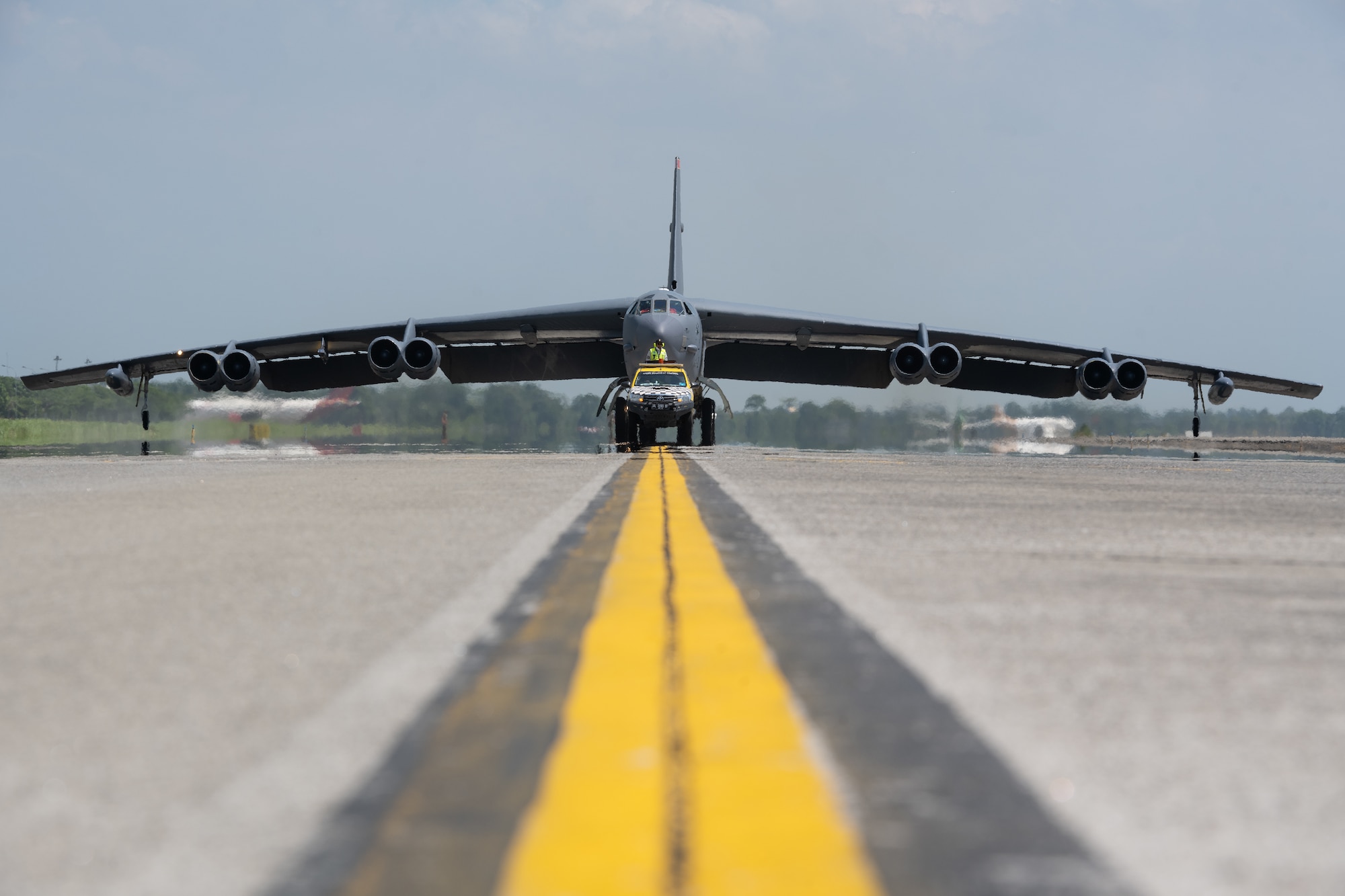 A U.S. Air Force B-52H Stratofortress assigned to the 23rd Bomb Squadron at Minot Air Force Base, North Dakota, sits on the flightline as another prepares to land at the Kualanamu International Airport in Medan, Indonesia, June 19, 2023. Two B-52s arrived in Indonesia to participate in bilateral training exercises, marking the first time U.S. Air Force B-52s had landed on Indonesian soil. (U.S. Air Force photo by Tech. Sgt. Zade Vadnais)