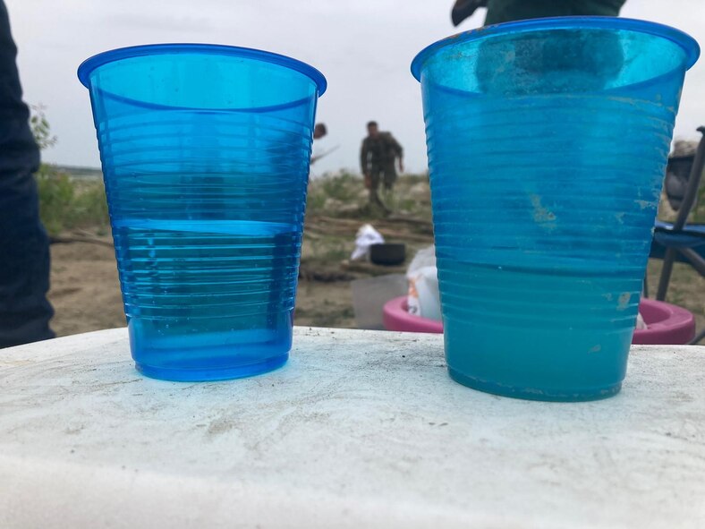 Airmen from the 5th Civil Engineering Squadron prepare potable water for a training event June 15, 2023 at Minot Air Force Base, North Dakota. The Airmen split into six groups and had to navigate using a map and compass to locate different stations across the designated training area. At these stations, they learned skills such as fire building, shelter building, filtering water, and catching and cooking wild game, in order to prepare themselves better for Agile Combat Employment deployments. (Courtesy photo.)