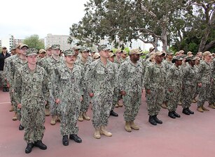 SAN DIEGO (June 9, 2023) Sailors from Information Warfare Training Command (IWTC) San Diego selected for promotion during the spring advancement cycle stand in formation awaiting to be “frocked” by friends and family.  IWTC San Diego, as part of the Center for Information Warfare Training, provides a continuum of training to Navy and joint service personnel that prepares them to conduct information warfare across the full spectrum of military operations.