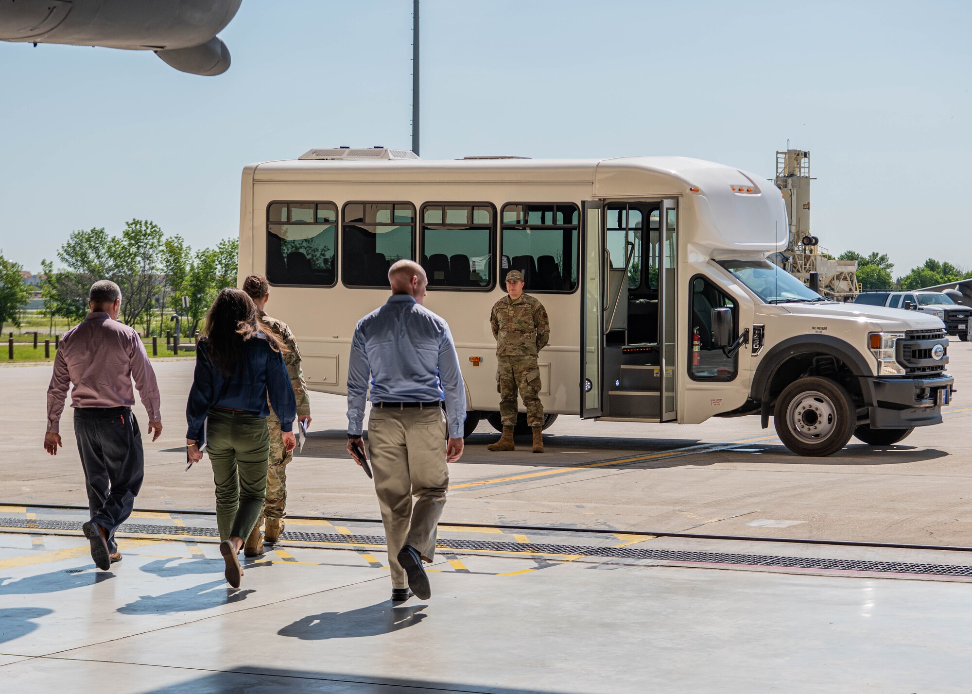 Team Minot Airmen render a salute to Col. Daniel Hoadley, 5th Bomb Wing commander, and North Dakota state staff delegates as they arrive to tour a hangar at Minot Air Force Base, North Dakota, June 26, 2023. The delegates were given the opportunity to enter the cockpit of a B-52H Stratofortress as part of the tour. (U.S. Air Force photo by Airman 1st Class Kyle Wilson)