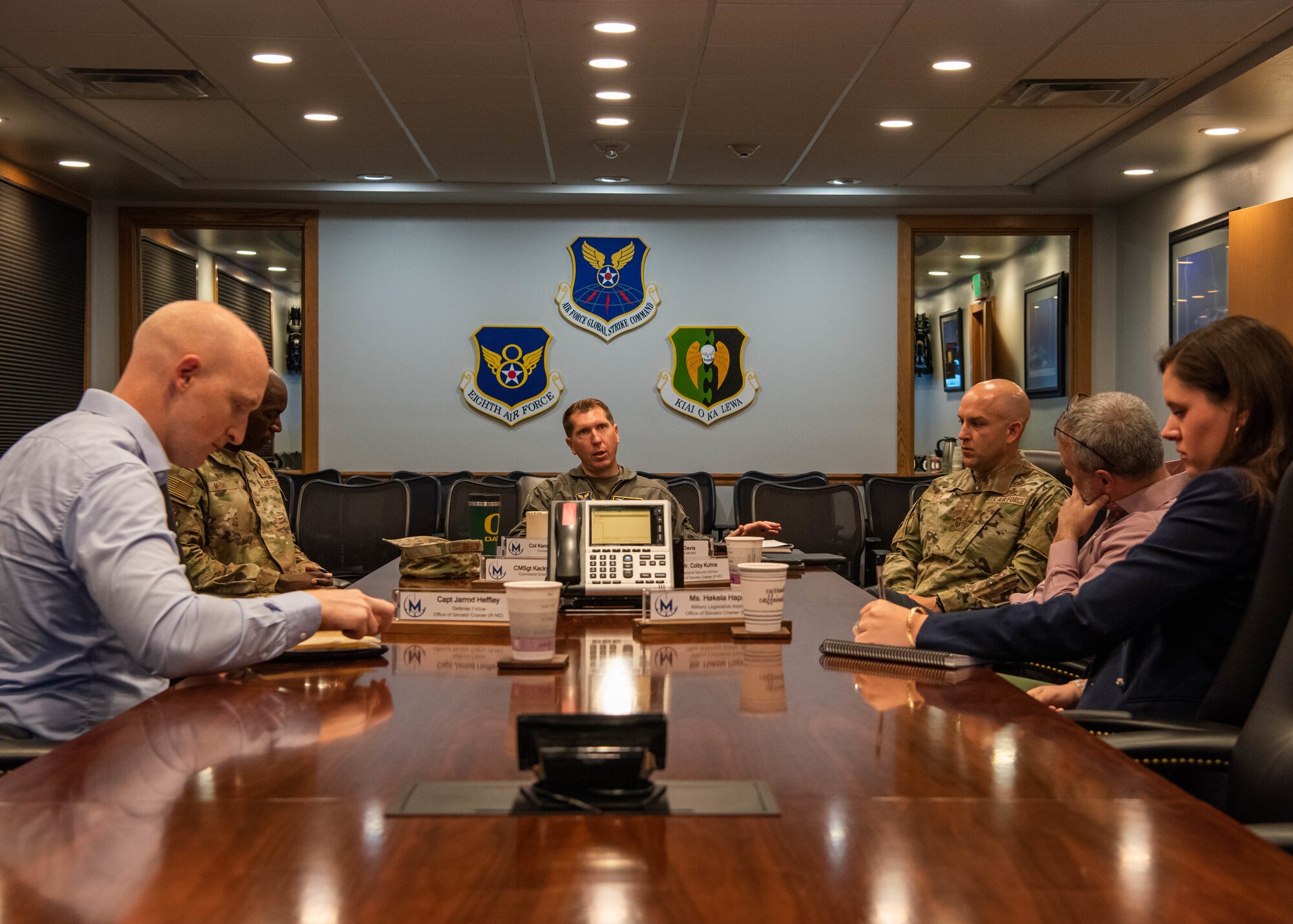 U.S. Air Force Col. Daniel Hoadley, 5th Bomb Wing commander, Col. Kenneth McGhee, 91st Missile Wing commander, and Chief Master Sgt. Jeremy Davis, 5th Munitions Squadron senior enlisted leader, provide a welcome brief to North Dakota state staff delegates at Minot Air Force Base, North Dakota, June 26, 2023. The brief covered information about Minot Air Force Base and the mission it serves. (U.S. Air Force photo by Airman 1st Class Kyle Wilson)