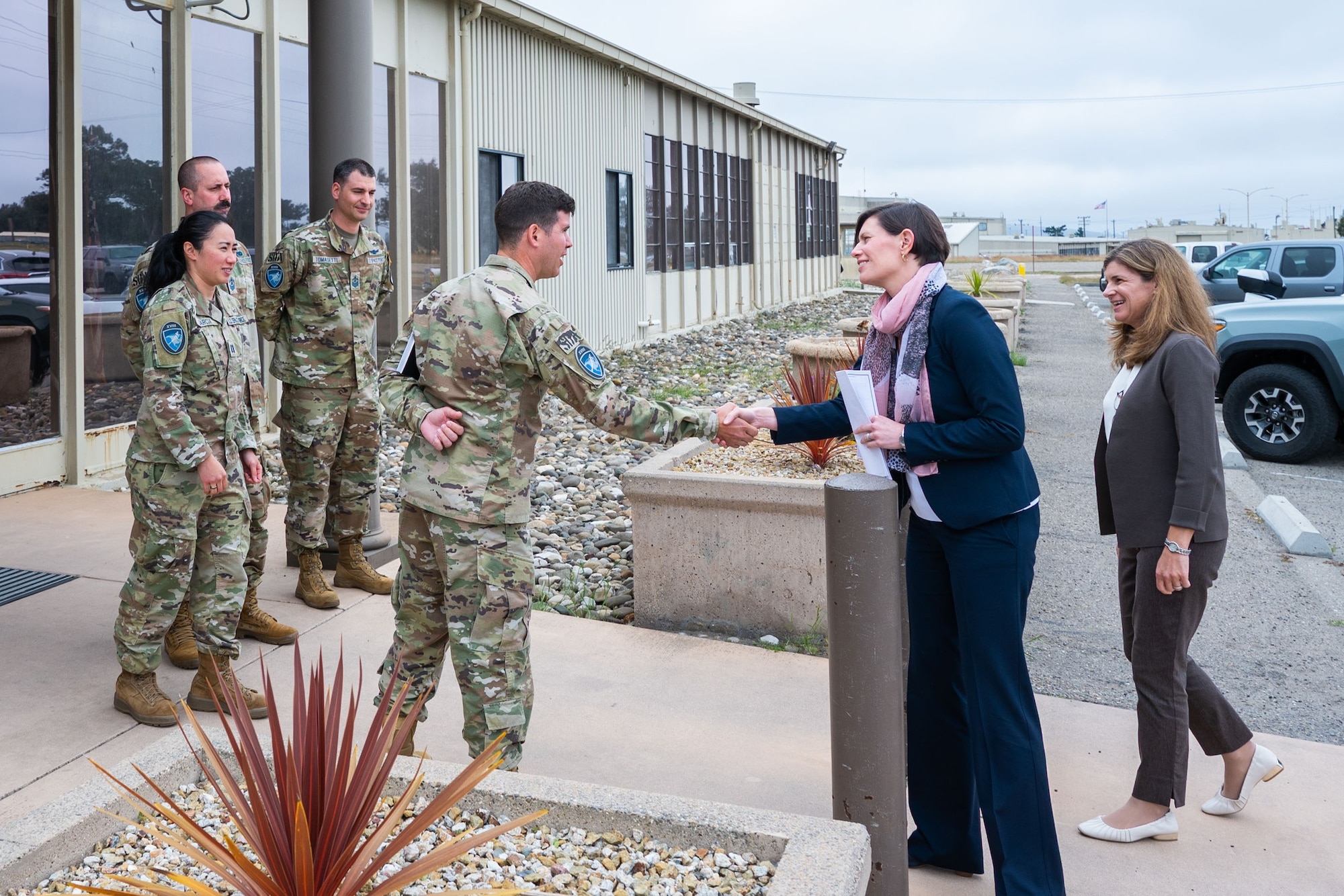 Members of the 18th Space Defense Squadron (18 SDS), including U.S. Space Force Lt. Col. Jordan O.E. Mugg, 18 SDS commander, middle, welcome Ms. Stephanie Miller, Deputy Assistant Secretary of Defense for Military Personnel Policy, middle-right, and Ms. Katharine Kelley, Deputy of Space Operations for Human Capital, right, to the 18 SDS building at Vandenberg Space Force Base, Calif., June 27, 2023. (U.S. Space Force photo by Tech. Sgt. Luke Kitterman)