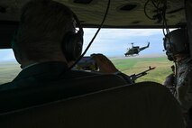 A helicopter is seen between the blackened silhouettes of two passengers in a separate aircraft.
