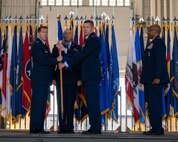 U.S. Air Force Col. Jeffrey Anderson, former 5th Maintenance Group (MXG) commander, relinquishes the guidon to Col. Daniel Hoadly, 5th Bomb Wing commander, during the 5th MXG change of command ceremony at Minot Air Force Base, North Dakota, June 29, 2023. The 5MXG provides both aircraft and munitions maintenance support for a fleet of 27 Boeing B-52 Stratofortress aircraft and a munitions stockpile. (U.S. Air Force photo by Senior Airman Evan Lichtenhan)