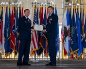 U.S. Air Force Col. Daniel Hoadly, 5th Bomb Wing commander, presents Col. Jeffrey Anderson, outgoing 5th Maintenance Group (MXG) commander, with the Legion of Merit at Minot Air Force Base, North Dakota, June 29, 2023. The Legion of Merit is awarded upon recognition of exceptionally meritorious conduct in the performance of outstanding services. (U.S. Air Force photo by Senior Airman Evan Lichtenhan)