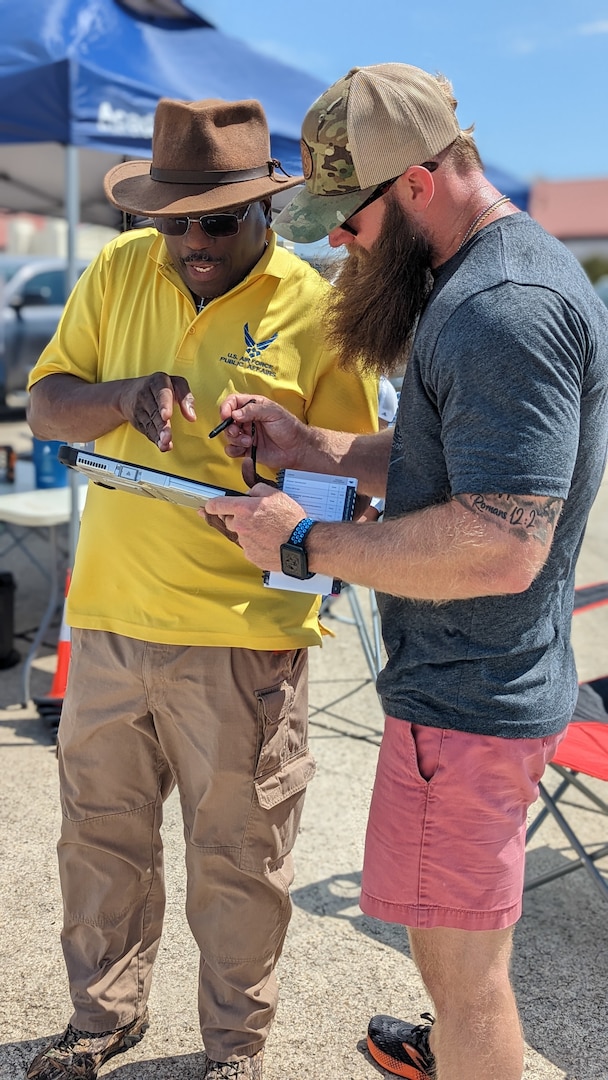 two males looking at a drone tablet