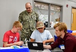 IMAGE: Naval Surface Warfare Center Dahlgren Division Commanding Officer Capt. Philip Mlynarski interacts with students during the 2023 STEM Summer Academy at King George Middle School, June 22.