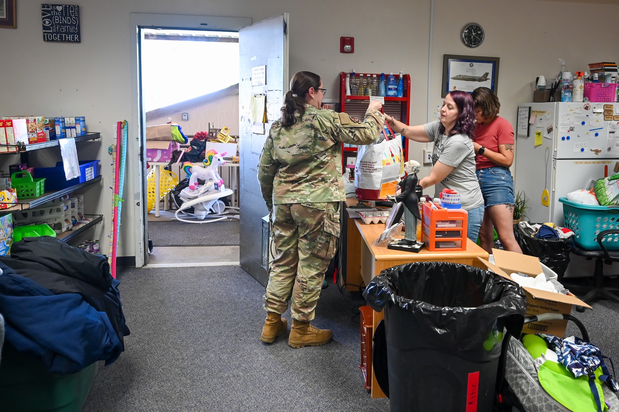 Sharaya Woodwick (middle), Airman's Attic manager, receives a donation June 27, 2023, at Hill Air Force Base, Utah. Airman's Attic provides free uniforms, clothing, household items and food to the military. (U.S. Air Force photo by Cynthia Griggs)