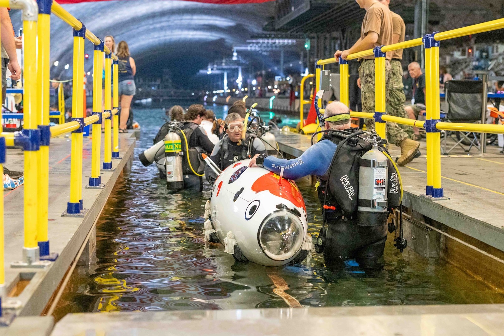 Teams enter the water at Naval Surface Warfare Center, Carderock Division's David Taylor Model Basin as they prepare for the 17th International Submarine Race in West Bethesda, Md., on June 29, 2023. (U.S. Navy photo by Aaron Thomas)