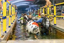 Teams enter the water at Naval Surface Warfare Center, Carderock Division's David Taylor Model Basin as they prepare for the 17th International Submarine Race in West Bethesda, Md., on June 29, 2023. (U.S. Navy photo by Aaron Thomas)