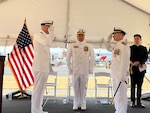 Cmdr. Adam Disque (left) and Cmdr. Brian Tesson (right) salute each other during the Coast Guard Cutter Active’s (WMEC 618) change of command ceremony in Port Angeles, Washington, June 28, 2023. Vice Adm. Andrew Tiongson, commander Coast Guard Pacific Area, presided over the ceremony where Disque relieved Tesson as Active’s 30th commanding officer. U.S. Coast Guard courtesy photo.