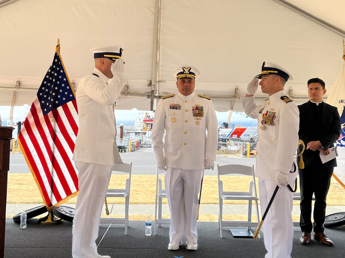 Cmdr. Adam Disque (left) and Cmdr. Brian Tesson (right) salute each other during the Coast Guard Cutter Active’s (WMEC 618) change of command ceremony in Port Angeles, Washington, June 28, 2023. Vice Adm. Andrew Tiongson, commander Coast Guard Pacific Area, presided over the ceremony where Disque relieved Tesson as Active’s 30th commanding officer. U.S. Coast Guard courtesy photo.