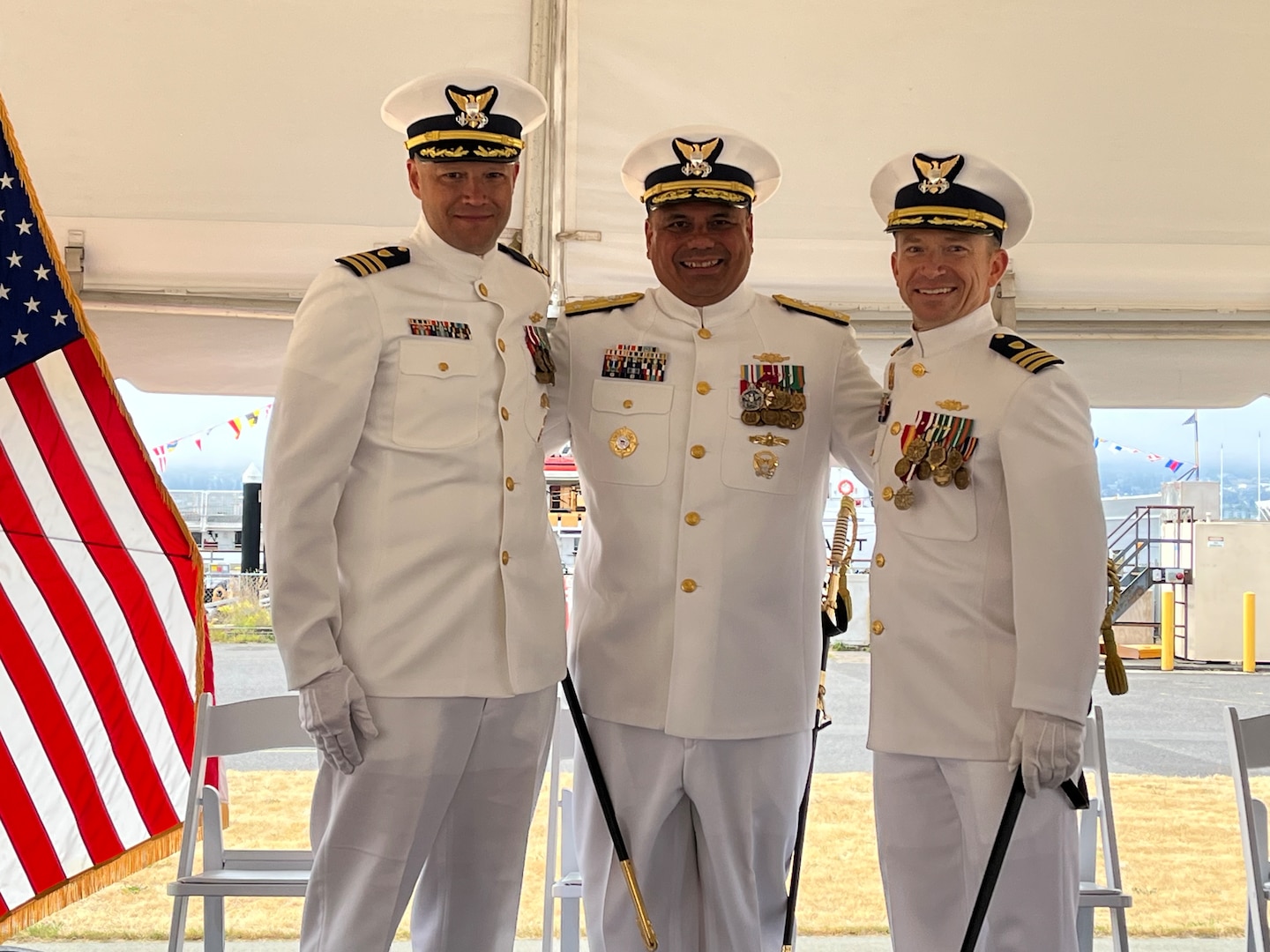 Cmdr. Adam Disque (left), Vice Adm. Andrew Tiongson, commander Coast Guard Pacific Area (center), and Cmdr. Brian Tesson (right) pose for a photo during the Coast Guard Cutter Active’s (WMEC 618) change of command ceremony in Port Angeles, Washington, June 28, 2023. Tiongson presided over the ceremony where Disque relieved Tesson as Active’s 30th commanding officer. U.S. Coast Guard courtesy photo.