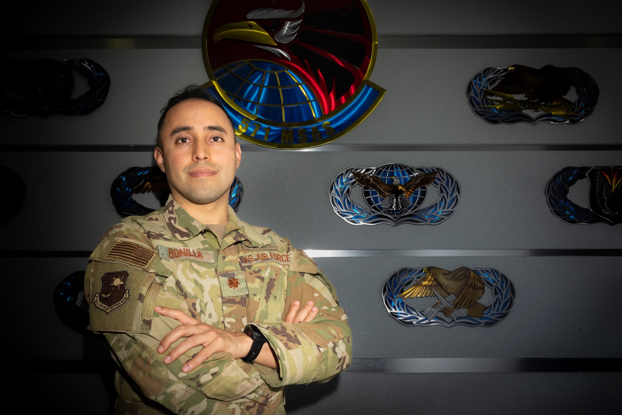 U.S. Air Force Maj. Jonathan Bonilla, a 621st Contingency Response Wing deputy director of staff, poses for a photo in front of the 571st Mobility Support Advisory Squadron, May 2, 2023, at Travis Air Force Base, California.