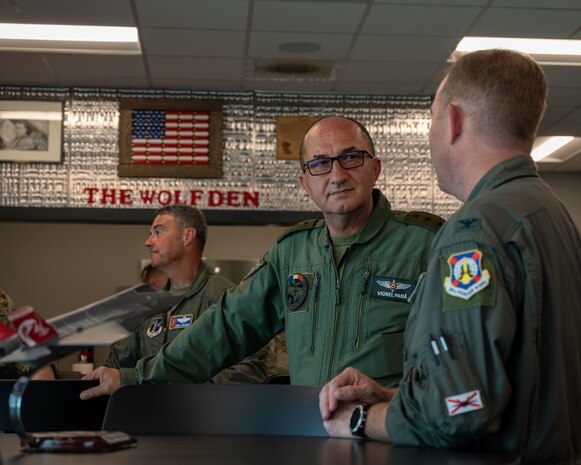 Chief of the Romanian Air Force Staff Lt. Gen.Viorel Pană discusses flying operations with 187th Fighter Wing Commander U.S. Air Force Col. Brian Vaughn, June 29, 2023, at Dannelly Field, Ala. The two air forces have shared lessons learned from F-16 maintenance to joint exercises overseas. The 187th FW is scheduled to transition from F-16s to F-35s, and the wing also provided an F-35 conversion tour for Pană and the Romanian delegation. (U.S. Air Force photo by 1st Lt. Michael Luangkhot)