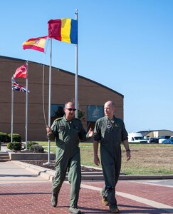 Col. Scott Gunn (right), Vice Commander of the 80th Flying Training Wing and Euro-NATO Joint Jet Pilot Training (ENJJPT), accompanies Chief of the Romanian Air Staff Lt. Gen. Viorel Pană (left) through “Flag Row” at the 80th Flying Training Wing en route to the ENJJPT building at Sheppard Air Force Base, Texas, June 29, 2023. Romania has been a member of ENJJPT since 2017 and the Romanian Air Force began training its first pilots there in May of 2019. (U.S. Air Force Photo by 1st Lt. Daniel Lindstrom)