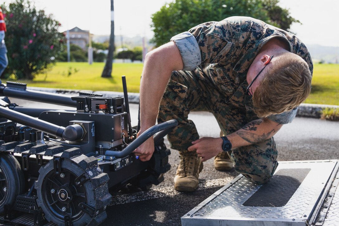 U.S. Marine Corps Sgt. Ian Heuer, an explosive ordnance disposal technician with Headquarters Battalion, Marine Corps Base Hawaii, prepares to deploy an EOD robot to inspect an area for simulated explosive hazards during Exercise Lethal Breeze 2023, Camp H. M. Smith, MCBH, June 28, 2023. The exercise was conducted in partnership with state and federal law enforcement and local first responders, with the purpose of enhancing cohesion, response proficiency, and safety measures throughout the installation. (U.S. Marine Corps photo by Cpl. Brandon Aultman)