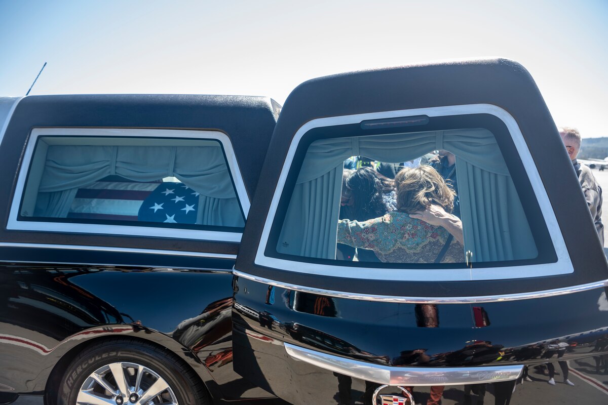 Joyce De Soto, widow of U.S. Air Force Col. Ernest De Soto, visits the casket of U.S. Air Force Col. Ernest De Soto during his dignified arrival at San Francisco International Airport, June 29, 2023. De Soto was killed in 1969 when his plane crashed into a mountain ridge during the Vietnam War. His remains were discovered in 1995, but it took more than 20 years for the Defense POW/MIA Accounting Agency (DPAA) to recover, identify and return them to his family in the Bay Area. (U.S. Air Force photo by Nicholas Pilch)