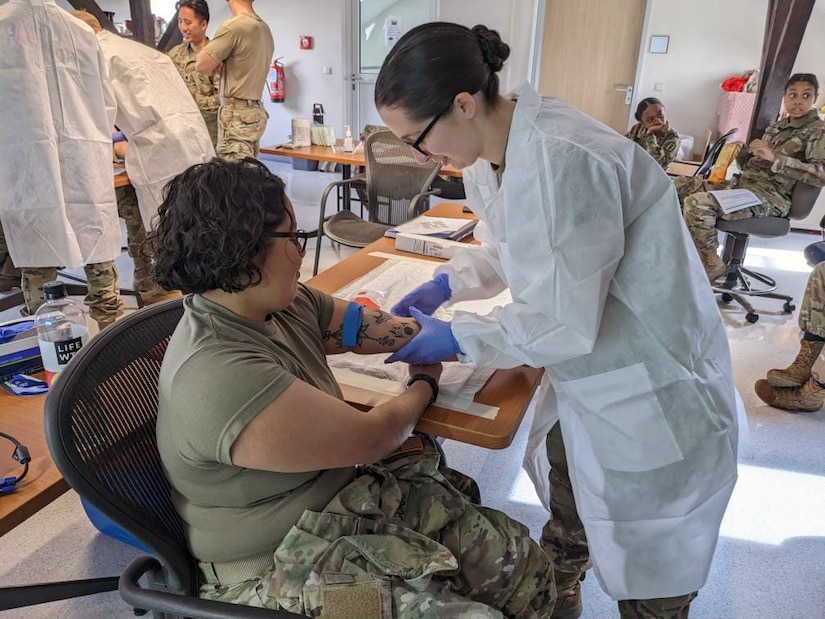 U.S. Army Reserve Spc. Zoe Horton, right, with the 341st Medical Logistics Company blood support section, collects a blood donation at the Armed Services Blood Bank Center-Europe at Landstuhl Regional Medical Center, Germany, during Operation Patriot Press in May. (Photo Credit: Sgt. Alanna Yeutter)