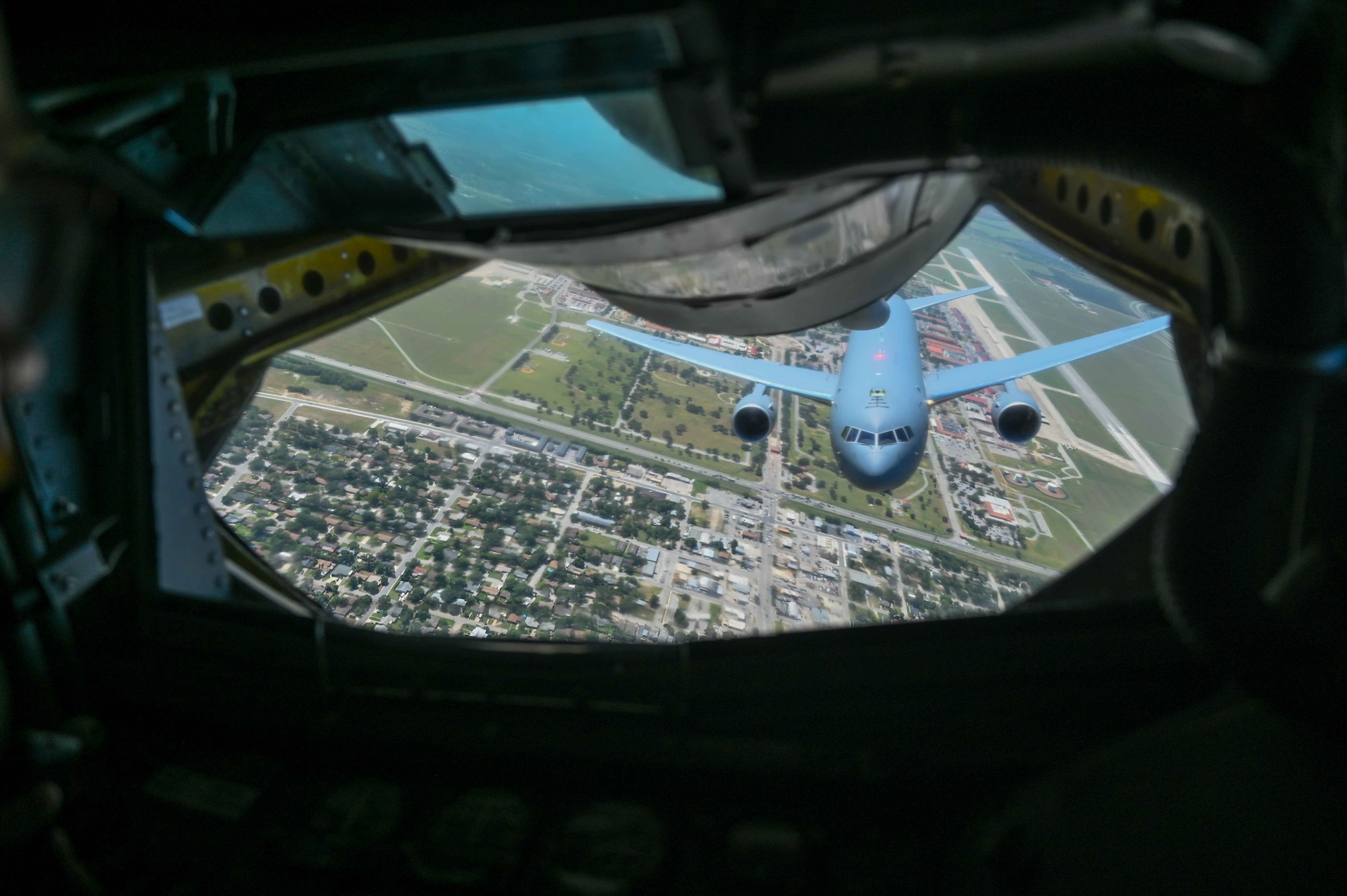 A KC-46 Pegasus flies under a KC-135 Stratotanker during the air refueling centennial flyover in Texas and Oklahoma, June 27, 2023. The flyover demonstration celebrated 100 years of air refueling. (U.S. Air Force photo by Airman 1st Class Kari Degraffenreed)