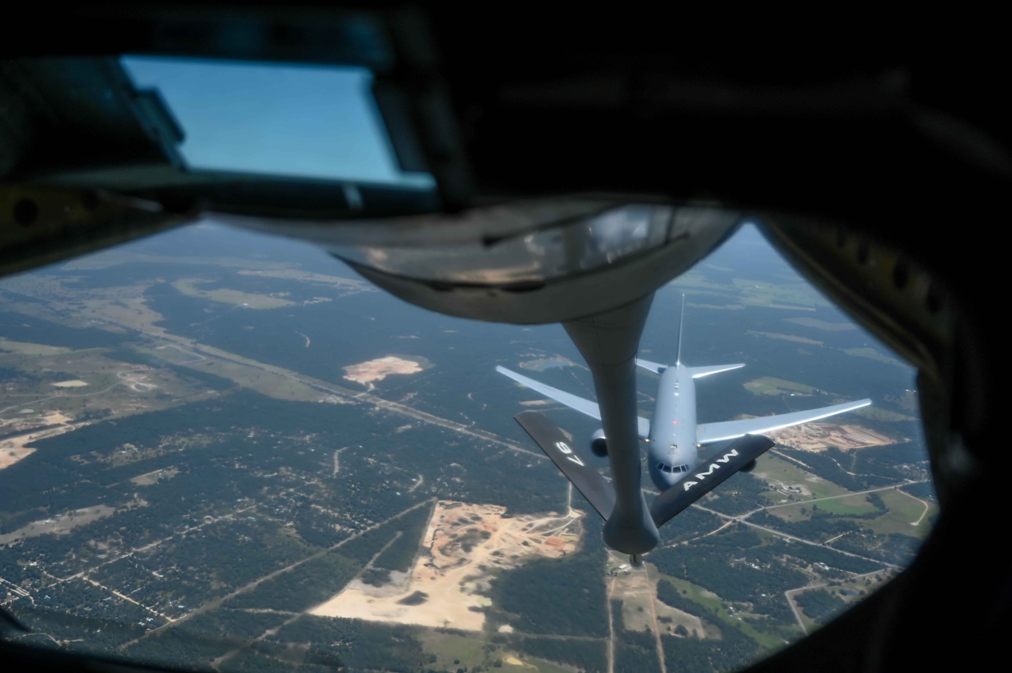 A KC-135 Stratotanker lowers the boom for a KC-46 Pegasus during the air refueling centennial flyover, June 27, 2023. The aircraft flew over Oklahoma and Texas landmarks to commemorate100 years of air refueling. (U.S. Air Force photo by Airman 1st Class Kari Degraffenreed)