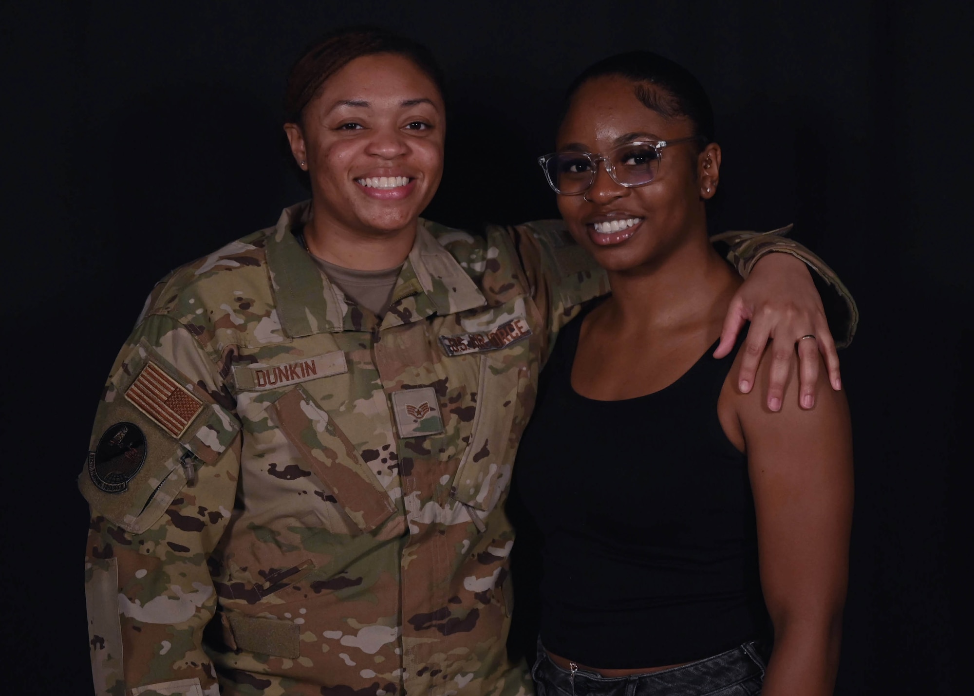 U.S. Air Force Staff Sgt. Shatora Dunkin, Louis F. Garland Department of Defense Fire Academy instructor, and her wife, Telisa Moye-Dunkin smile at Goodfellow Air Force Base, Texas, June 28, 2023. They originally met in 2018 at Basic Military Training and continued to grow their relationship for the next two years, through technical training and their first duty stations, before getting married in 2020. (U.S. Air Force photo by Airman 1st Class Madison Collier)