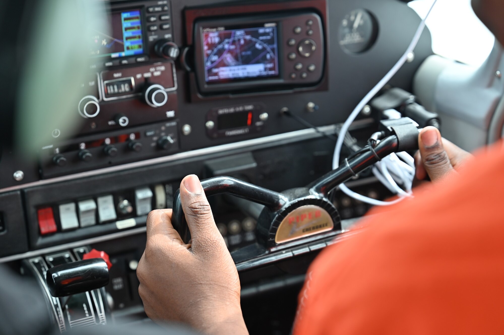 A Eyes Above the Horizon student manipulates flight controls during a flight.