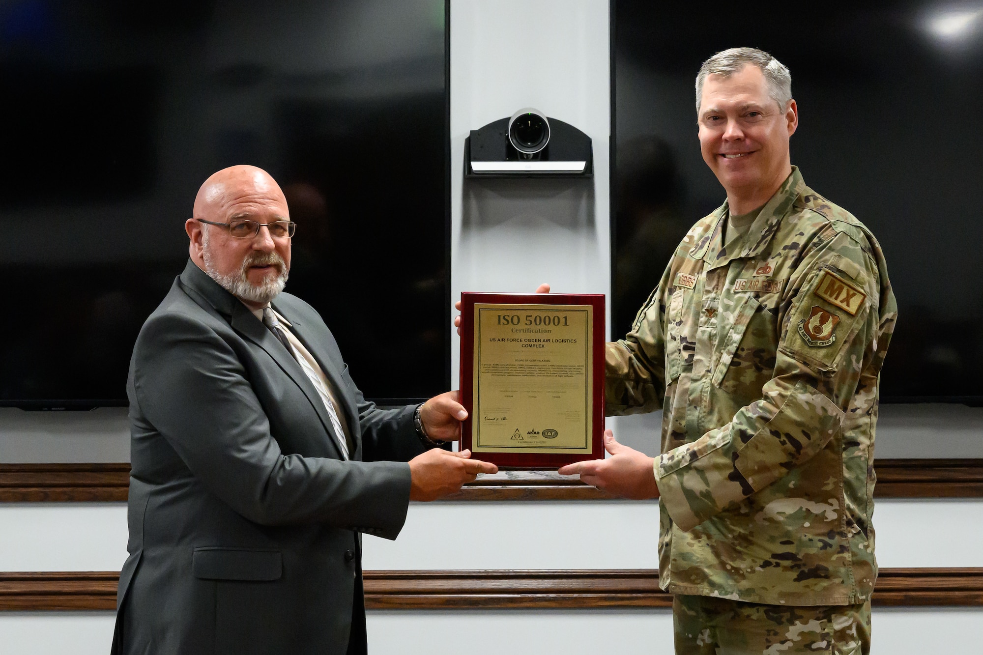 Harry Briesmaster and Col Chritopher Hobbs holding the ISO 50001 recertification plaque.