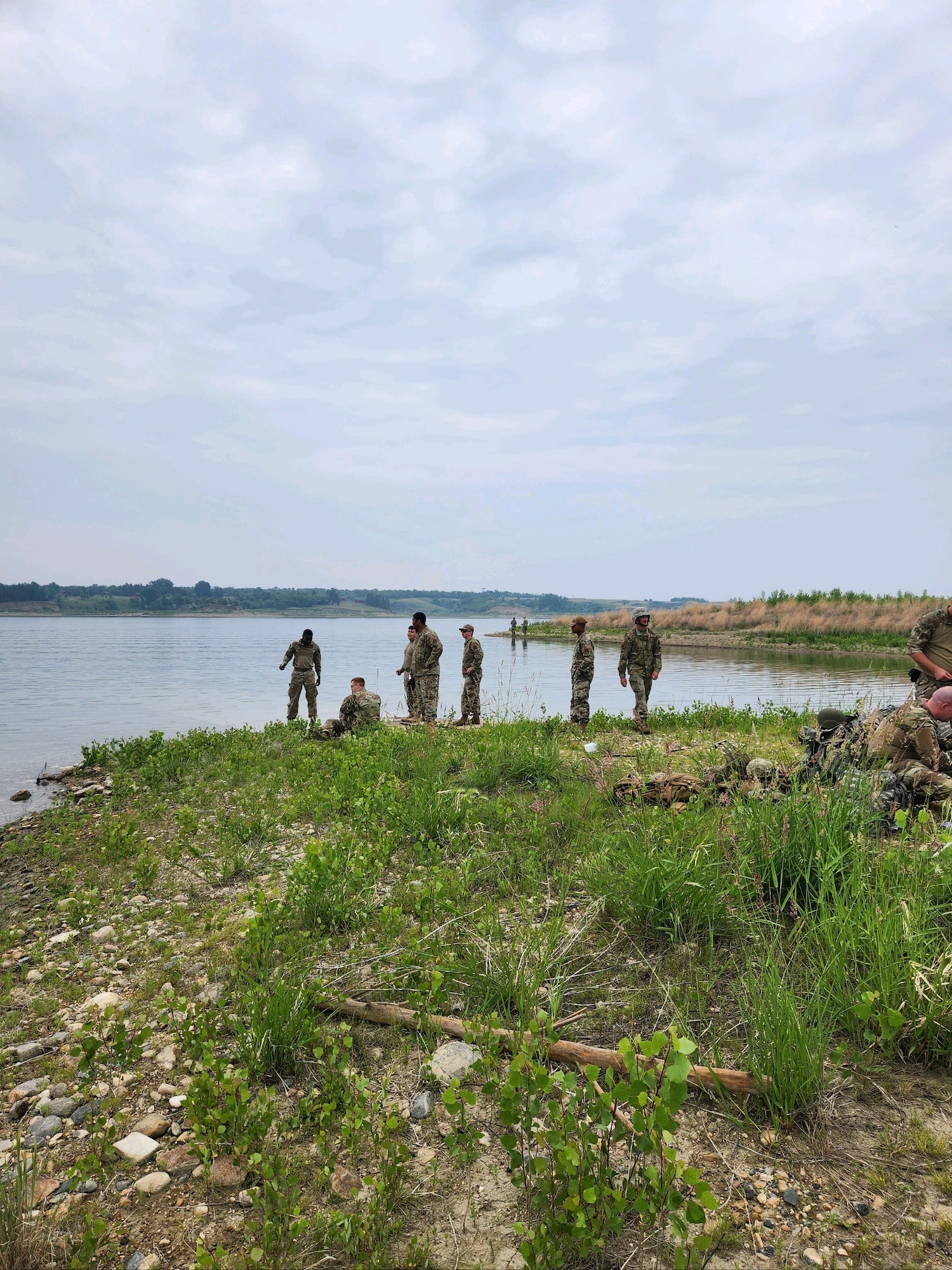 Airmen from the 5th Civil Engineering Squadron catch fish for a training event June 15, 2023 at Minot Air Force Base, North Dakota. The Airmen learned lifesaving skills such as finding food, water, and shelter in the wilderness in order to prepare themselves better for Agile Combat Employment deployments. (Courtesy photo.)