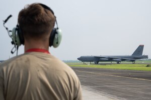 A U.S. Airman assigned to the 5th Aircraft Maintenance Squadron at Minot Air Force Base, North Dakota, prepares to marshal a B-52H Stratofortress assigned to the 23rd Bomb Squadron following a bilateral military training exercise at the Kualanamu International Airport in Medan, Indonesia, June 21, 2023. The U.S. Air Force routinely and visibly demonstrates commitment to its allies and partners through the global employment of military forces. This particular training flight marked the first time a U.S. Air Force B-52 had taken off from Indonesian soil. (U.S. Air Force photo by Tech. Sgt. Zade Vadnais)