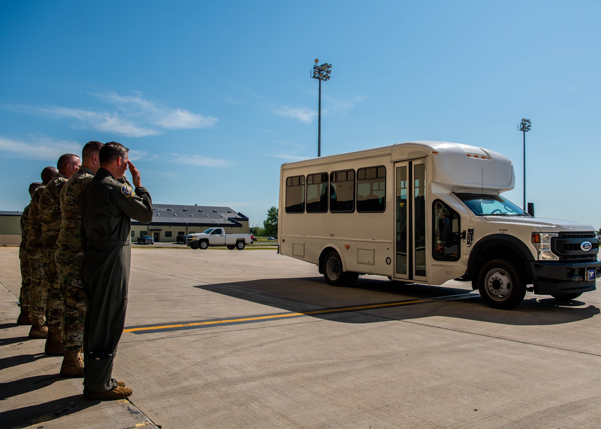Team Minot Airmen render a salute to Col. Daniel Hoadley, 5th Bomb Wing commander, and North Dakota state staff delegates as they arrive to tour a hangar at Minot Air Force Base, North Dakota, June 26, 2023. The delegates were given the opportunity to enter the cockpit of a B-52H Stratofortress as part of the tour. (U.S. Air Force photo by Airman 1st Class Kyle Wilson)