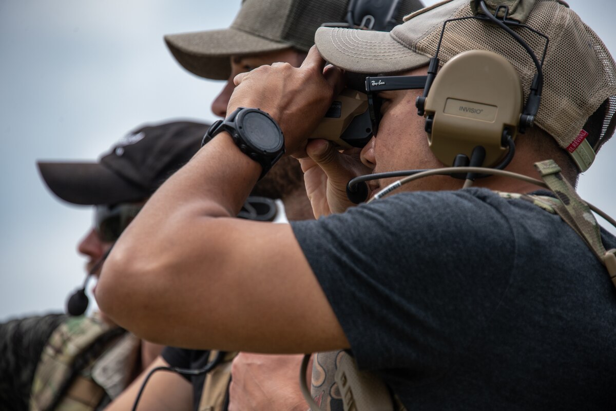 From right: U.S. Air Force Senior Airman Richie Thammavongsa, Staff Sgt. Henry Castagnetta, and Senior Airman Jarret Tyra, all tactical air control party specialists with the 146th Air Support Operations Squadron, 137th Special Operations Wing, Oklahoma National Guard, determine the distance to a point using a pocket laser range finder as the team rehearses reconnaissance operations during exercise Air Defender 2023 (AD23) in Germany June 19, 2023. Exercise AD23 is a German-led exercise that integrates both U.S. and Allied air-power to defend shared values, while leveraging and strengthening vital partnerships to deter aggression around the world. (U.S. Air National Guard photo by Tech. Sgt. Brigette Waltermire)