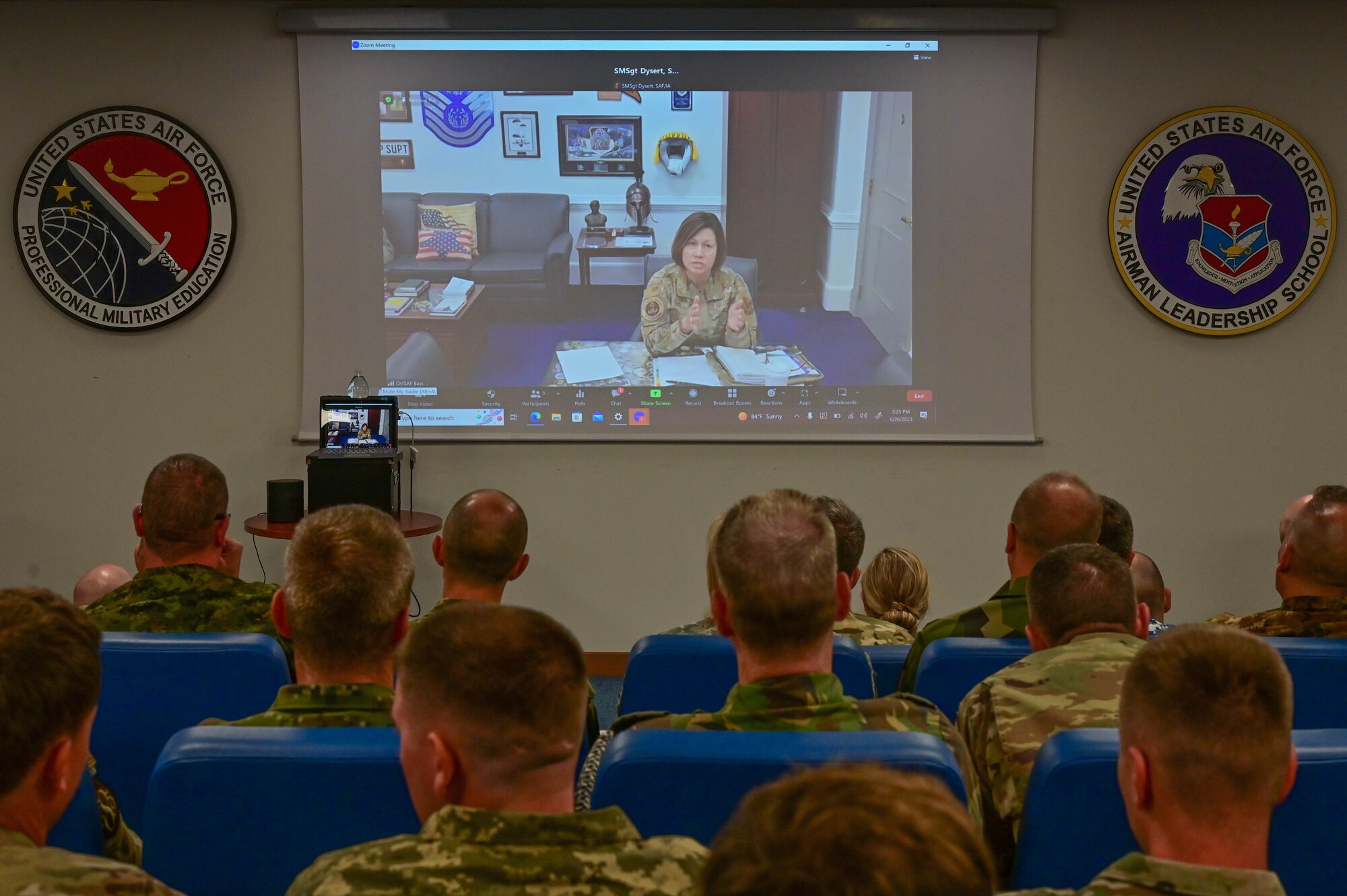 A group of people video call with Chief Bass