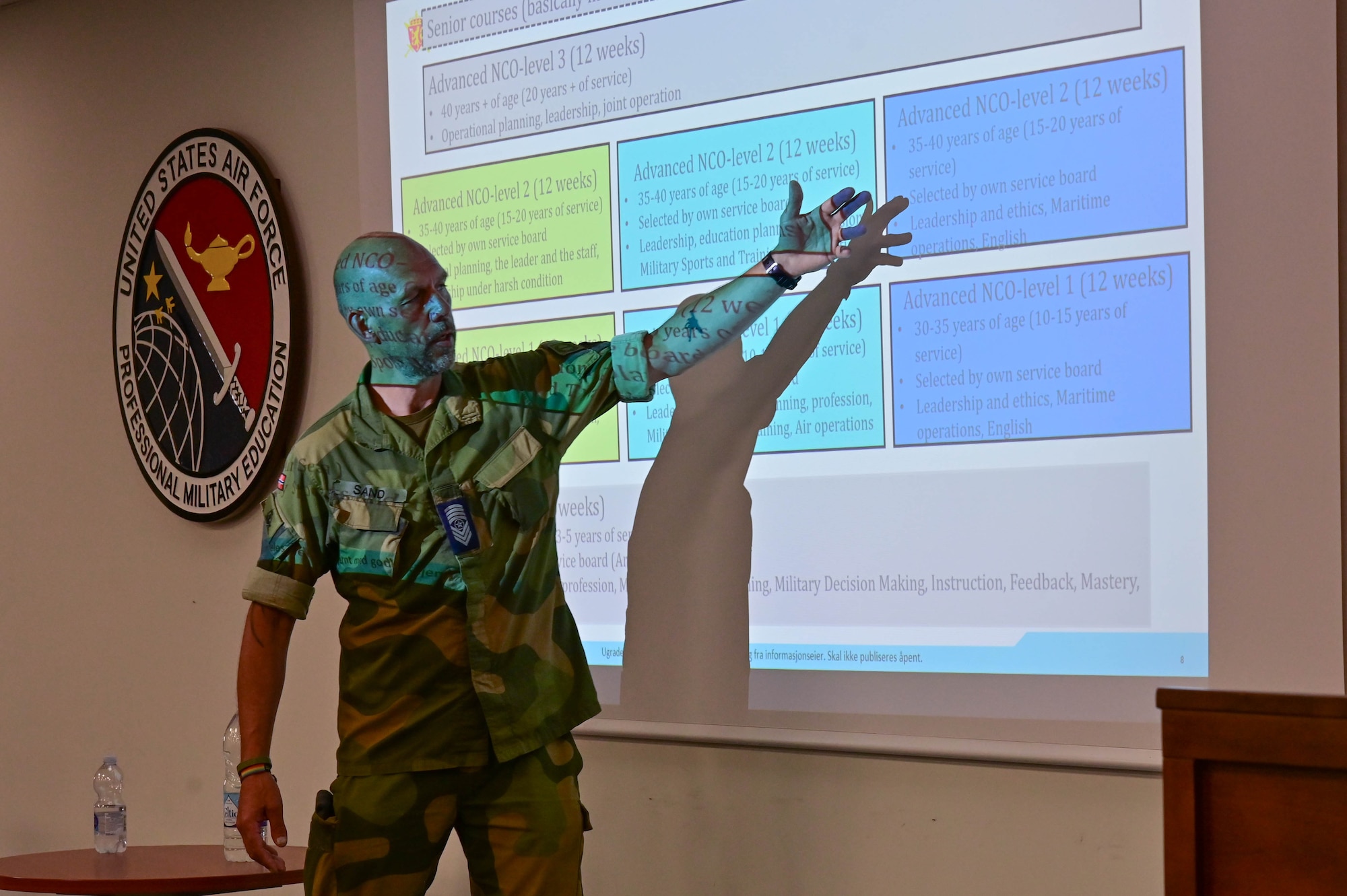 A man points at a projector screen