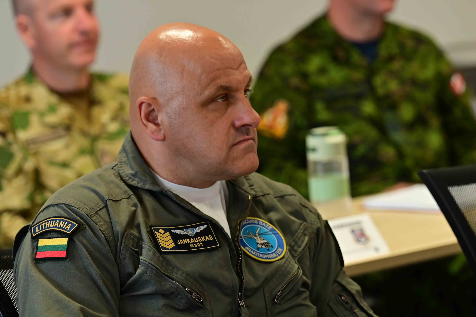 A senior leader sits in a brief
