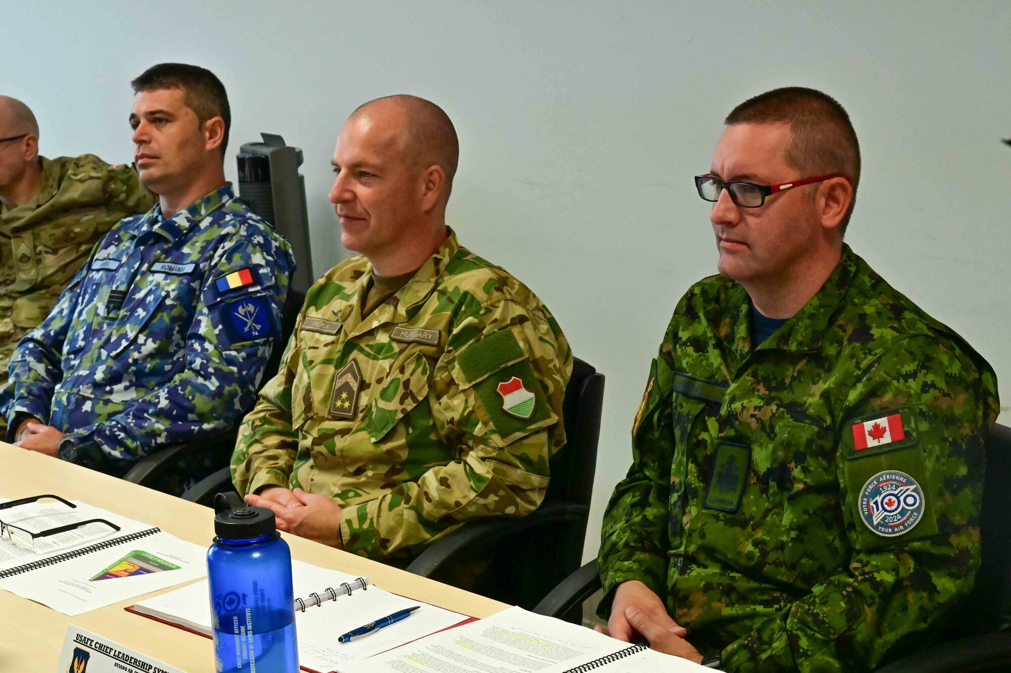 senior leaders listen to a brief