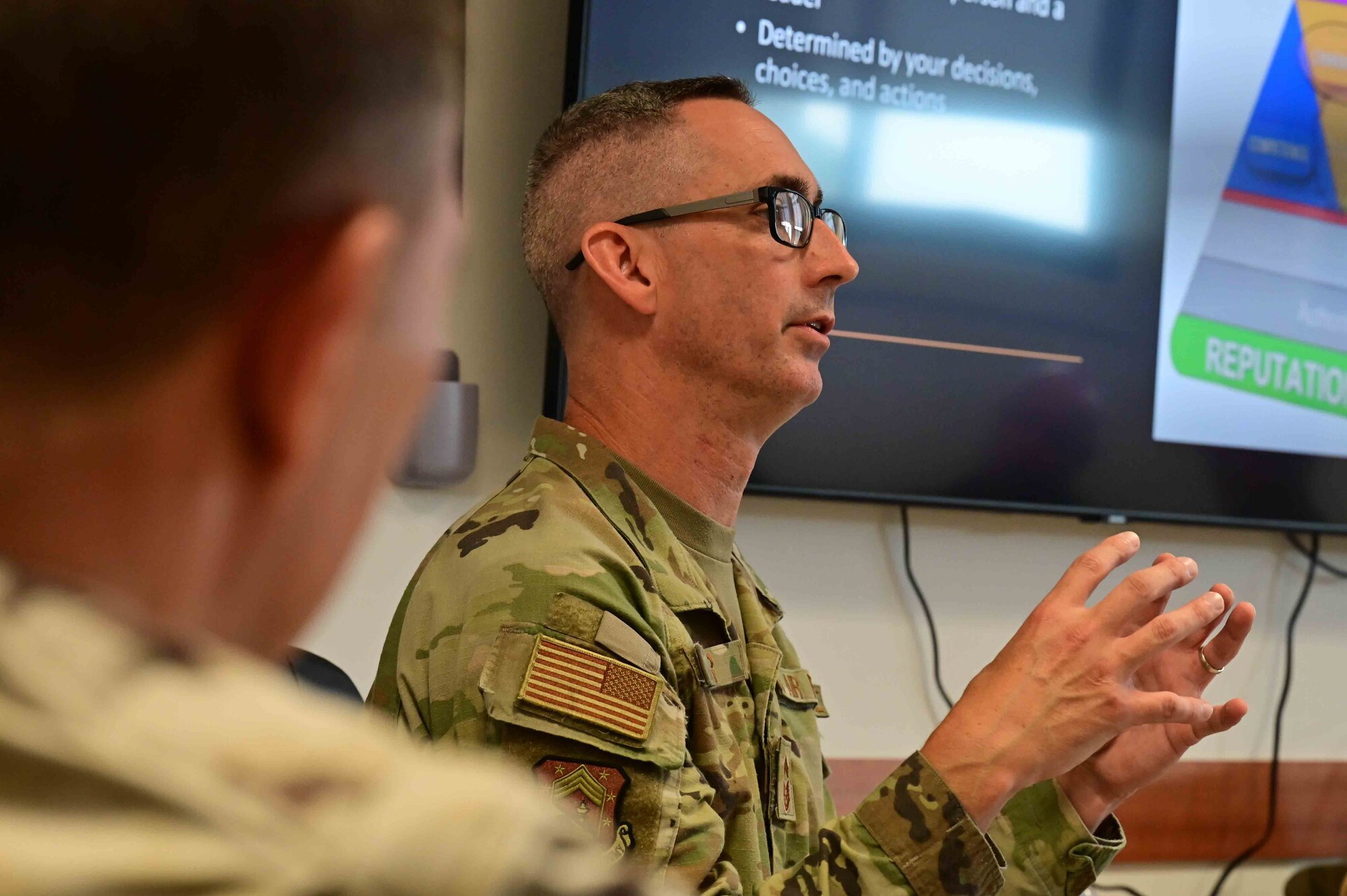 a senior leader speaks during a brief