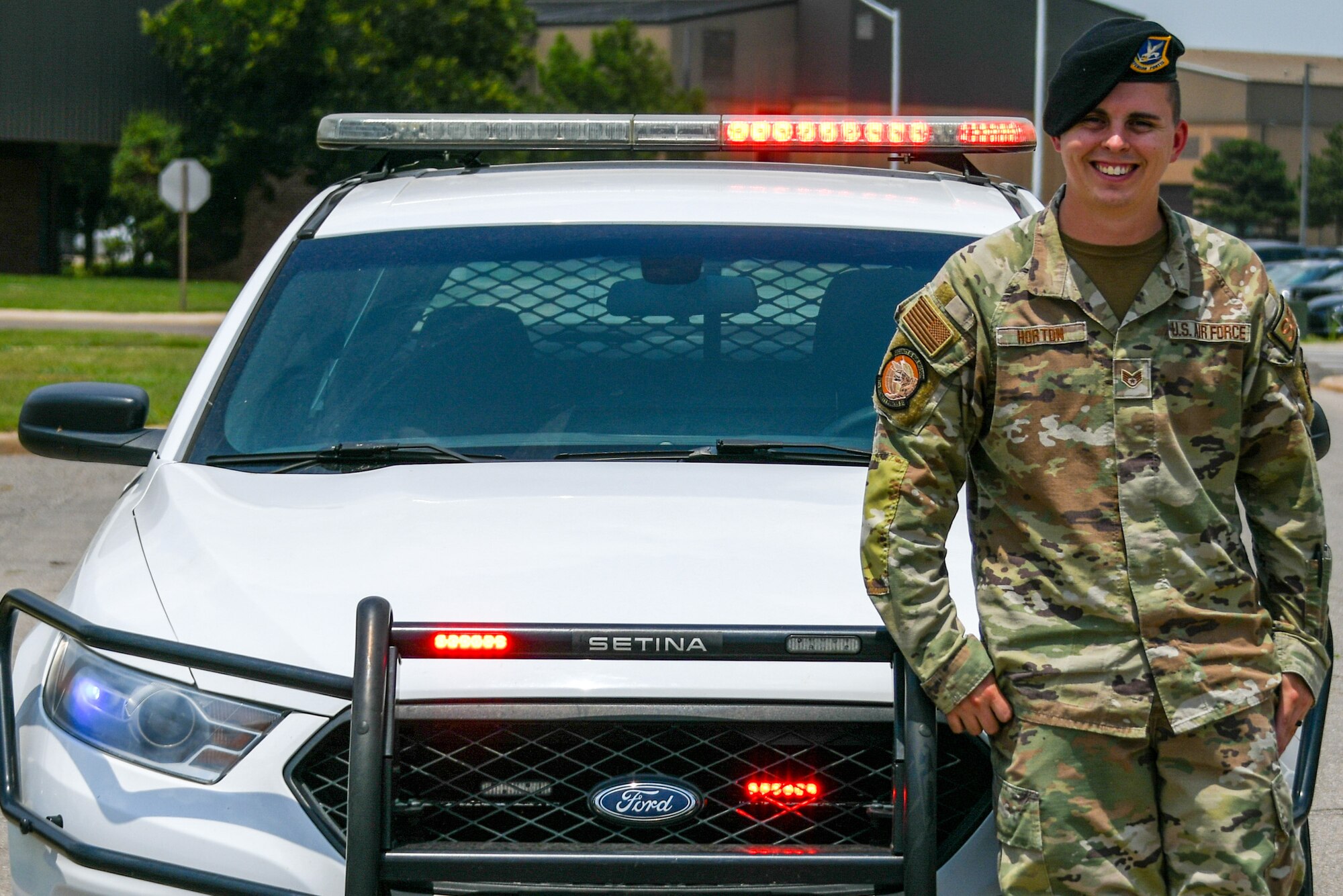 U.S. Air Force Staff Sgt. Zachary Horton, 97th Security Forces unit training manager, poses for a photo in front of a patrol car at Altus Air Force Base, Oklahoma, June 22, 2023. Horton reenlisted in 2022 to explore new places, build his career, and
acquire invaluable skills. (U.S. Air Force photo by Airman 1st Class Miyah Gray)