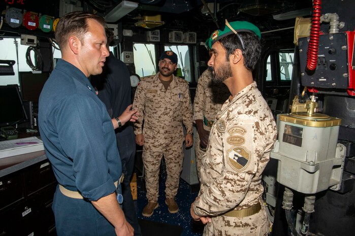 230226-N-NH267-1139 ARABIAN GULF (Feb. 26, 2023) Cmdr. Jake Ferrari, commanding officer of guided-missile destroyer USS Paul Hamilton (DDG 60), speaks with Bahrain Defence Force Maj. Manjoor Ali Alkhldi in the Arabian Gulf, Feb. 26, 2023. Paul Hamilton is deployed to the U.S. 5th Fleet area of operations to help ensure maritime security and stability in the Middle East region.