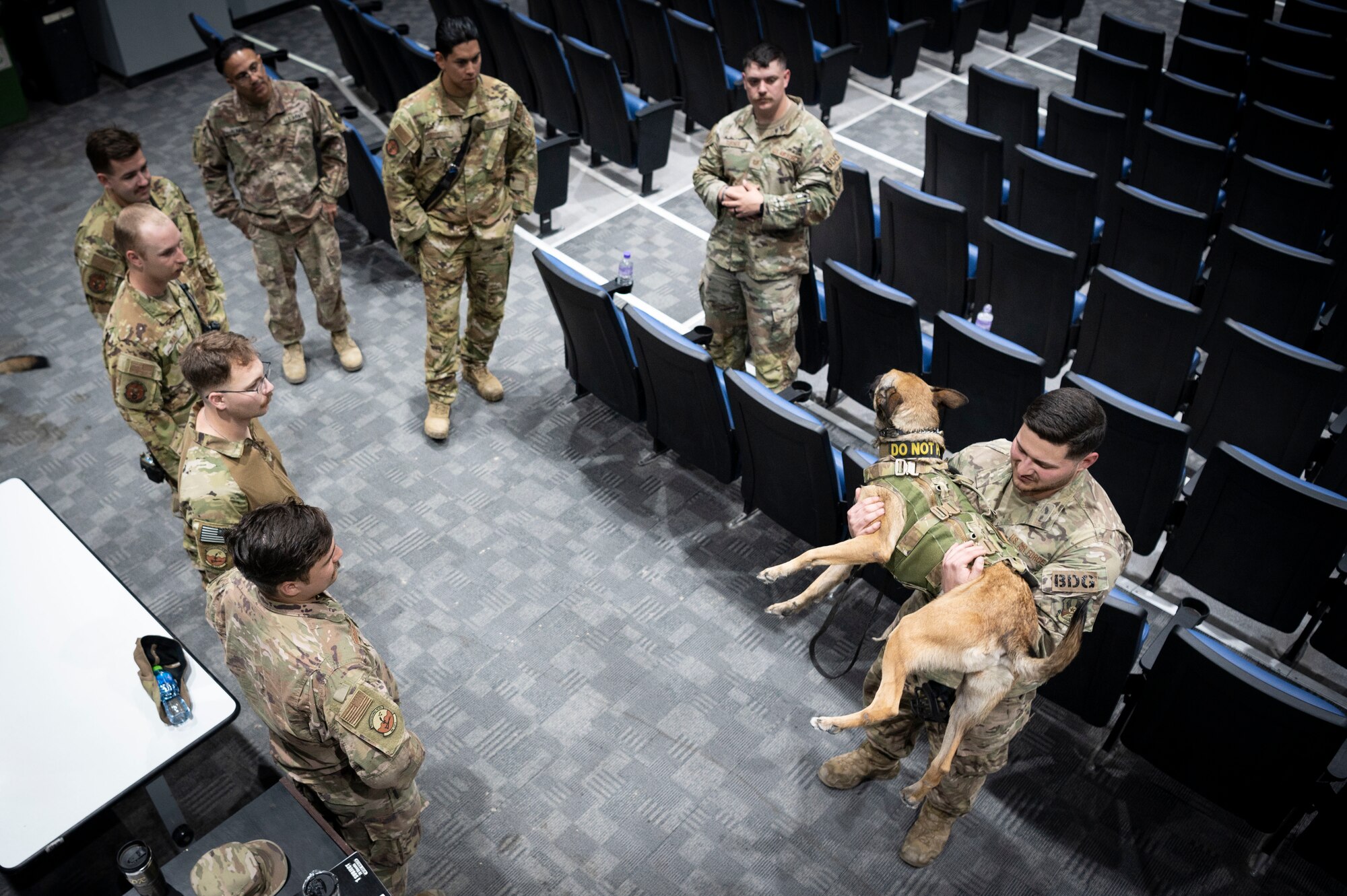 U.S. Air Force Senior Airman Sean Capan, a 386th Expeditionary Security Forces Squadron Military Working Dog handler, shows first responders one way to lift a MWD during a MWD emergency medical training at Ali Al Salem Air Base, Kuwait, Feb. 28, 2023.
