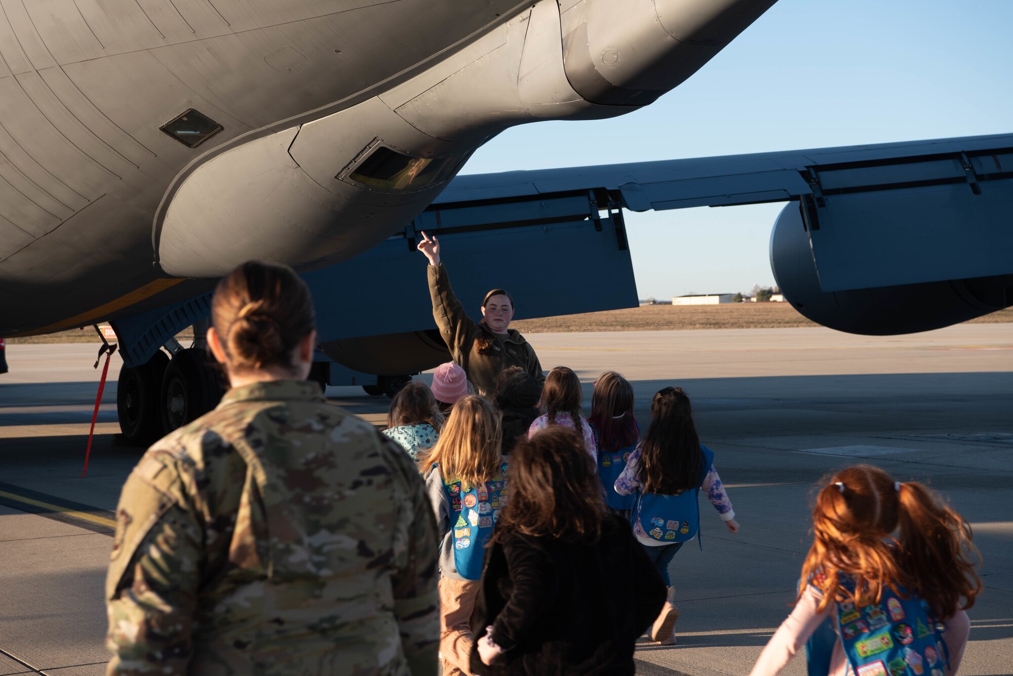 Little kids look at an aircraft.