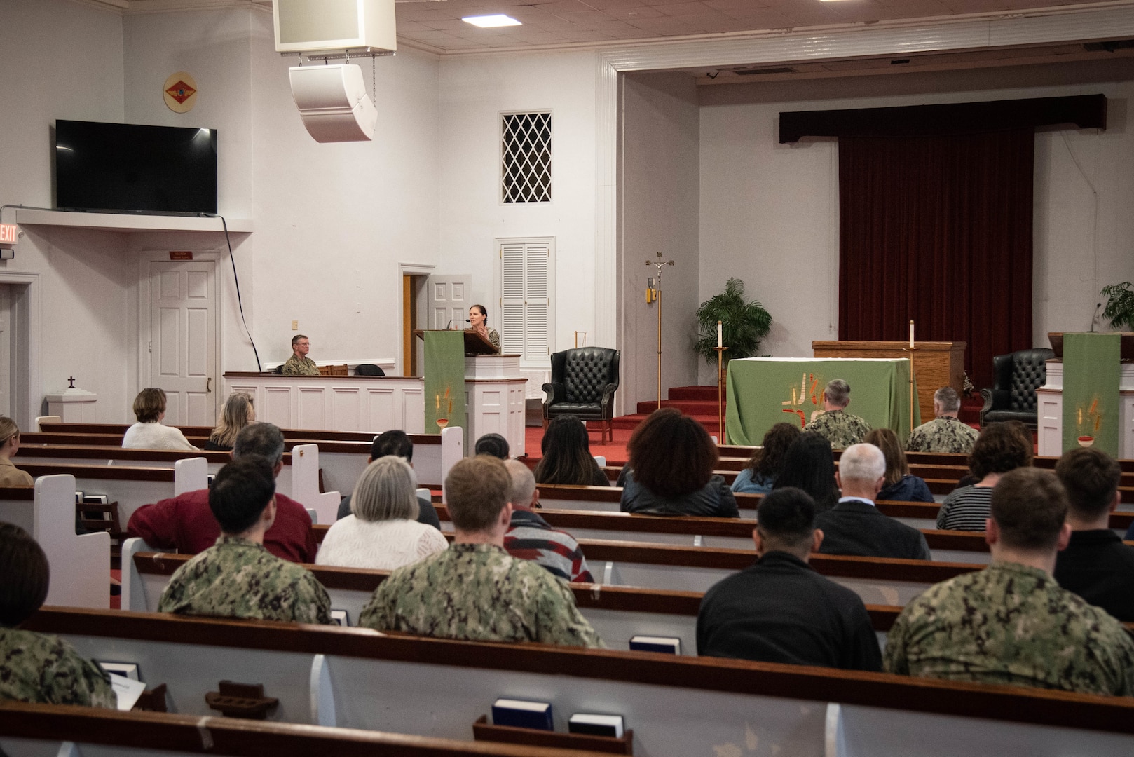 Navy Captain Elizabeth Adriano, Commander of Naval Health Clinic Cherry Point, speaks during a memorial ceremony celebrating the life of the late Hospitalman Luigi D. Giovanni held Thursday, February 2 at the Marine Corps Air Station Cherry Point Chapel.  Giovanni served aboard the clinic as a Pharmacy Technician prior to his passing late January, 2023.