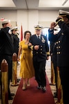 Cmdr. Travis Peterson escorts his wife, Margaret, as their family is “Piped Ashore” during a ceremony celebrating his retirement after more than thirty years of active-duty service in the U.S. Navy.  Peterson retired during a ceremony conducted Friday, February 24 aboard Marine Corps Air Station Cherry Point, N.C.