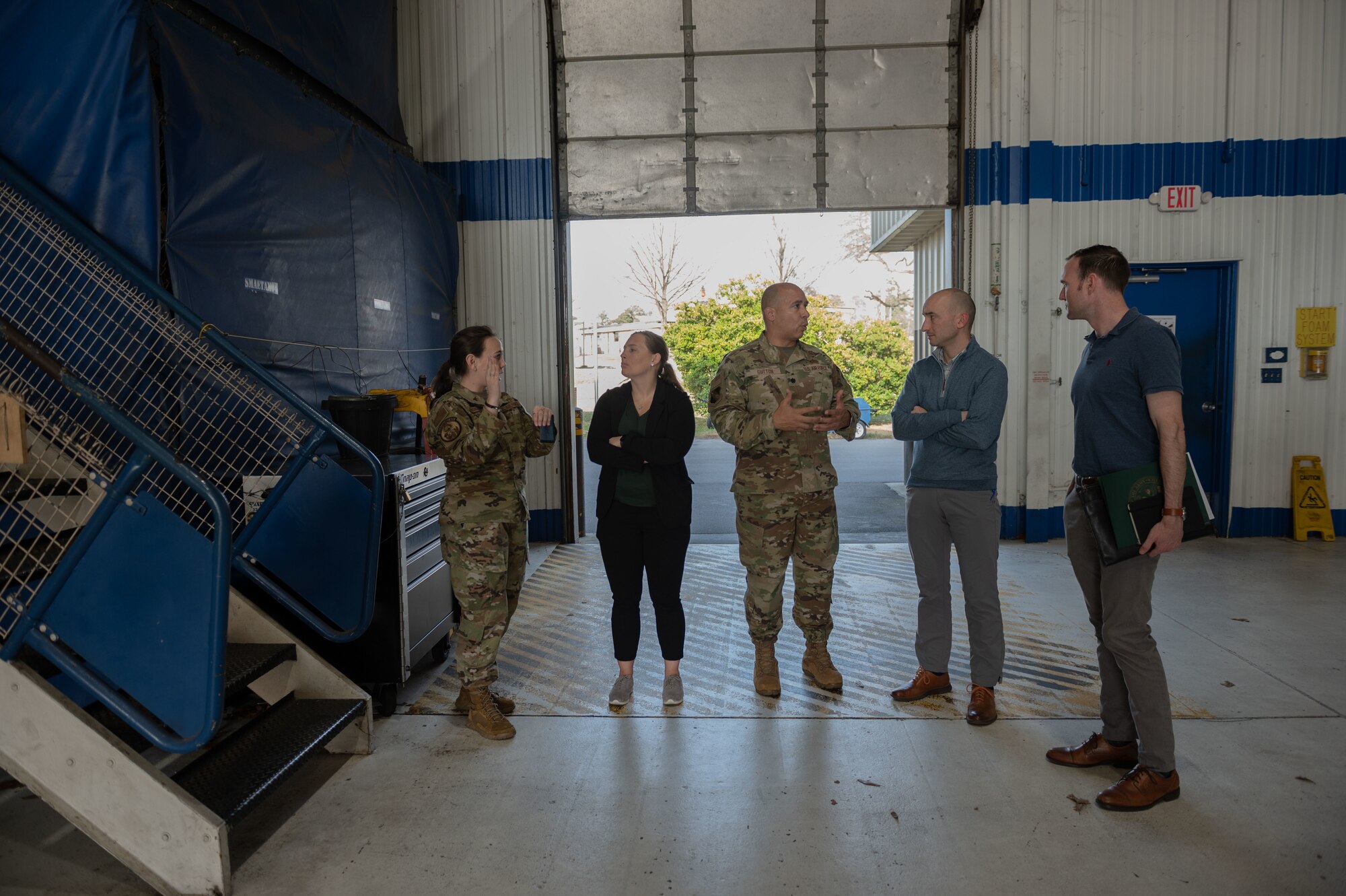 Airmen assigned to the 4th Fighter Wing give a tour of a hangar to staff delegation members during their visit at Seymour Johnson Air Force Base, North Carolina, Feb. 22, 2023. STAFFDEL members visited the base to discuss aircrew production. (U.S. Air Force photo by Airman 1st Class Rebecca Sirimarco-Lang)